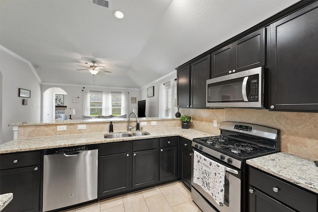 12915 Taper Reach Dr, Tomball, TX 77377 - kitchen featuring appliances with stainless steel finishes, ceiling fan, ornamental molding, a peninsula, and decorative backsplash
