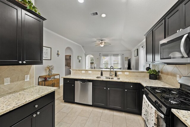 12915 Taper Reach Dr, Tomball, TX 77377 - kitchen featuring appliances with stainless steel finishes, ceiling fan, ornamental molding, decorative backsplash, and a peninsula