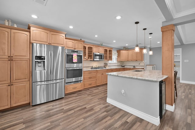 833 Stone Mountain Dr, Conroe, TX 77302 - kitchen with stainless steel appliances, crown molding, a sink, wood finished floors, and glass insert cabinets