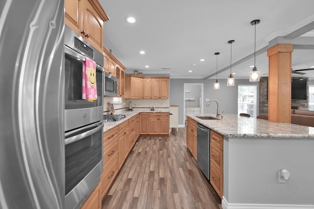 833 Stone Mountain Dr, Conroe, TX 77302 - kitchen with a sink, appliances with stainless steel finishes, wood finished floors, crown molding, and recessed lighting