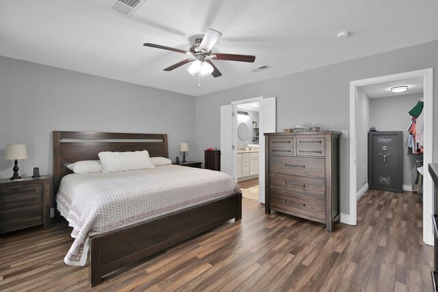 833 Stone Mountain Dr, Conroe, TX 77302 - bedroom featuring dark wood finished floors, baseboards, ensuite bathroom, and a ceiling fan