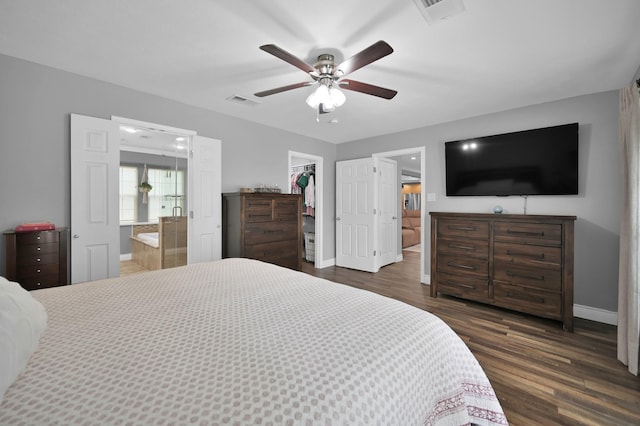 833 Stone Mountain Dr, Conroe, TX 77302 - bedroom with a walk in closet, baseboards, dark wood finished floors, a closet, and connected bathroom
