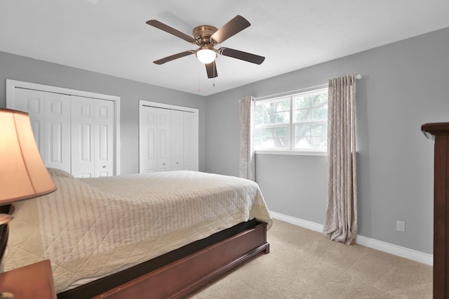833 Stone Mountain Dr, Conroe, TX 77302 - carpeted bedroom with two closets, baseboards, and ceiling fan