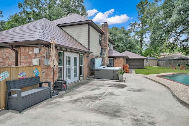 833 Stone Mountain Dr, Conroe, TX 77302 - rear view of house with french doors, a patio area, brick siding, and a chimney