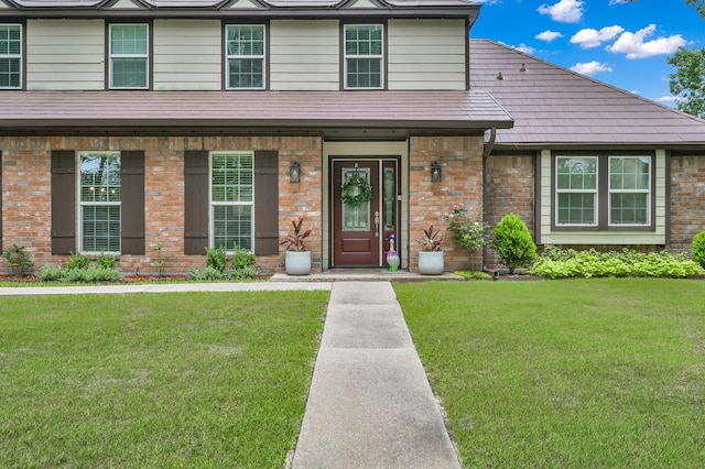 833 Stone Mountain Dr, Conroe, TX 77302 - view of front facade with a front yard, brick siding, and covered porch
