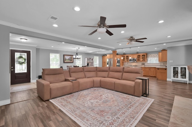 833 Stone Mountain Dr, Conroe, TX 77302 - living area with crown molding, baseboards, recessed lighting, ceiling fan, and wood finished floors