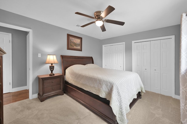 833 Stone Mountain Dr, Conroe, TX 77302 - bedroom featuring two closets, light carpet, baseboards, and a ceiling fan