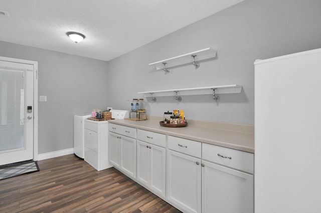 833 Stone Mountain Dr, Conroe, TX 77302 - bar with separate washer and dryer, dark wood-style flooring, a textured ceiling, and baseboards