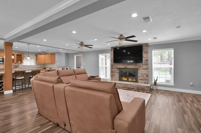 833 Stone Mountain Dr, Conroe, TX 77302 - living room featuring ornamental molding, recessed lighting, dark wood-type flooring, a fireplace, and baseboards