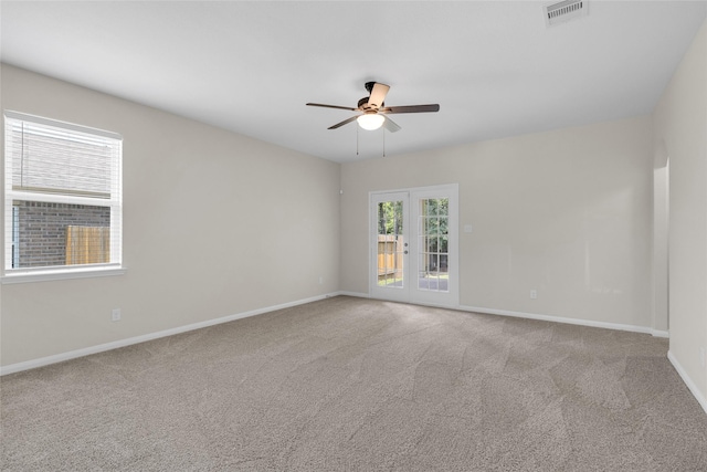 7571 Fettle Ln, Conroe, TX 77304 - carpeted spare room with a ceiling fan, baseboards, and french doors