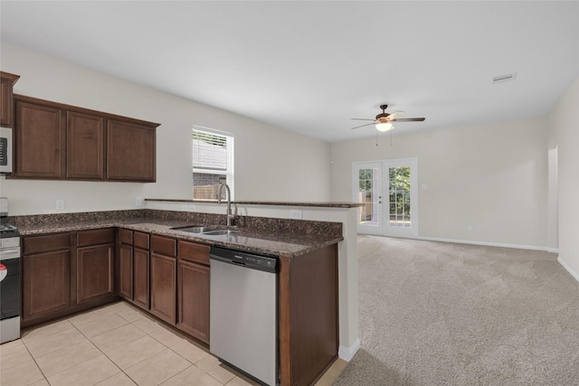 7571 Fettle Ln, Conroe, TX 77304 - kitchen featuring stainless steel appliances, a sink, a peninsula, and plenty of natural light