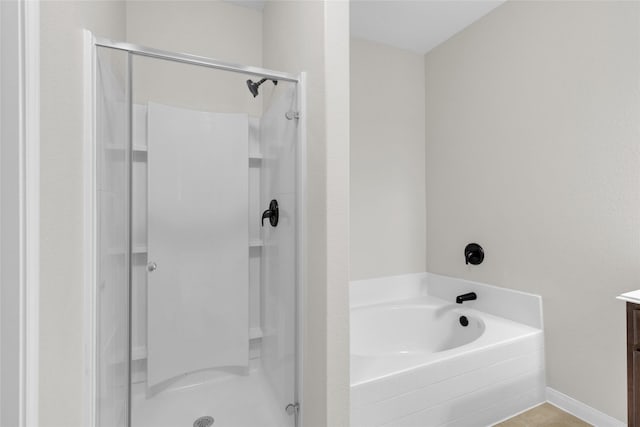 7571 Fettle Ln, Conroe, TX 77304 - bathroom featuring a stall shower, a garden tub, and vanity