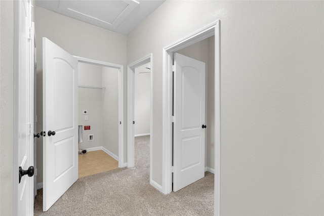 7571 Fettle Ln, Conroe, TX 77304 - corridor featuring light carpet and attic access