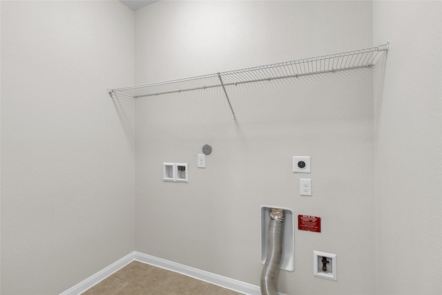 7571 Fettle Ln, Conroe, TX 77304 - laundry room with hookup for an electric dryer, washer hookup, baseboards, and light tile patterned floors