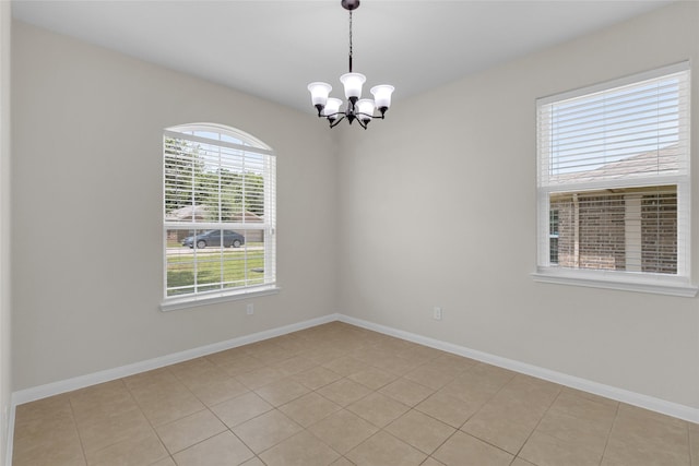 7571 Fettle Ln, Conroe, TX 77304 - unfurnished room featuring a chandelier, baseboards, and light tile patterned floors