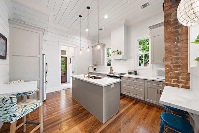 2019 Crockett St, Houston, TX 77007 - kitchen featuring gray cabinetry, a sink, healthy amount of natural light, appliances with stainless steel finishes, and ornamental molding