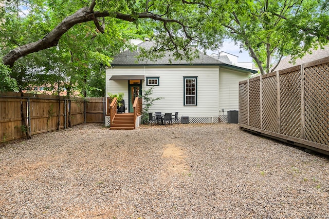 2019 Crockett St, Houston, TX 77007 - back of house featuring a fenced backyard, central air condition unit, a shingled roof, and crawl space