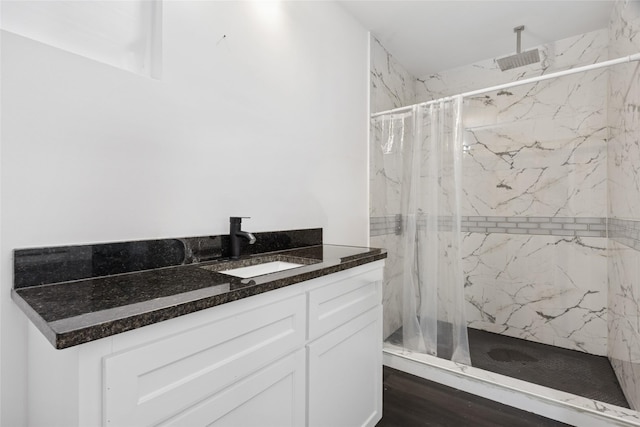 5614 Malmedy Rd, Houston, TX 77033 - full bathroom featuring a marble finish shower, vanity, and wood finished floors