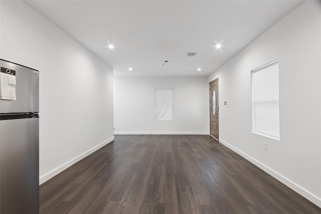 5614 Malmedy Rd, Houston, TX 77033 - unfurnished room featuring dark wood-style floors, baseboards, and recessed lighting