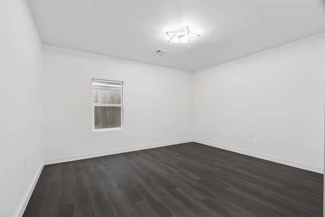 5614 Malmedy Rd, Houston, TX 77033 - spare room with dark wood-style floors and baseboards