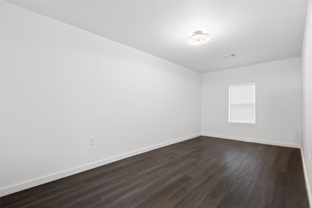 5614 Malmedy Rd, Houston, TX 77033 - empty room with baseboards and dark wood-style flooring