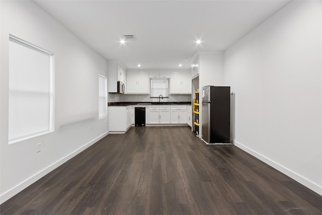5614 Malmedy Rd, Houston, TX 77033 - kitchen with stainless steel appliances, dark countertops, dark wood-style floors, baseboards, and recessed lighting
