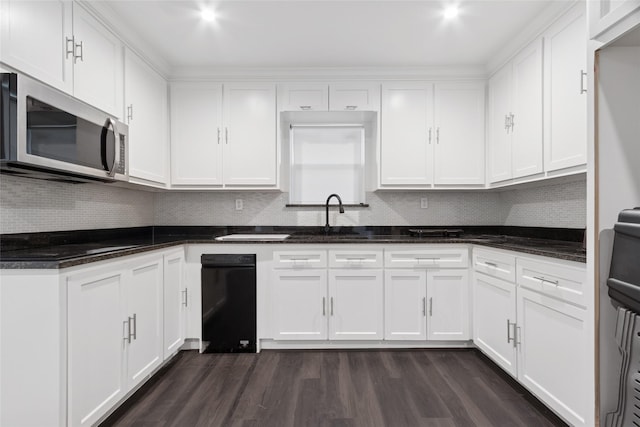 5614 Malmedy Rd, Houston, TX 77033 - kitchen featuring stainless steel microwave, white cabinets, and tasteful backsplash