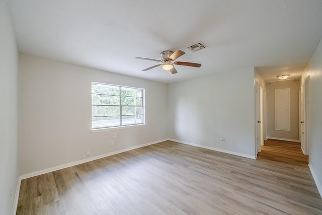 11063 Vailview Dr, Houston, TX 77016 - empty room with light wood-style flooring, ceiling fan, and baseboards