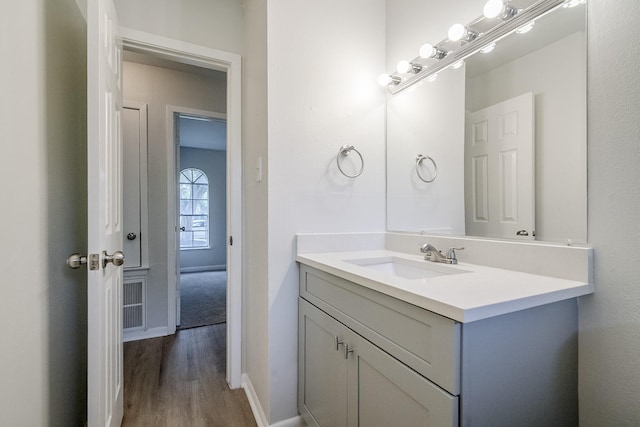11063 Vailview Dr, Houston, TX 77016 - bathroom featuring vanity, wood finished floors, and baseboards