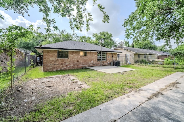 11063 Vailview Dr, Houston, TX 77016 - back of property featuring a patio, brick siding, and central AC unit