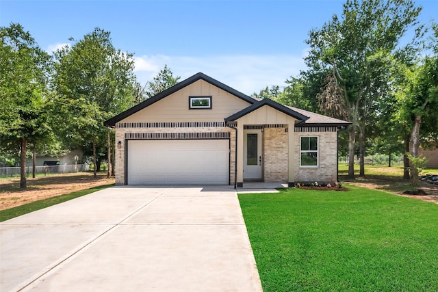 708 Azalea St, Prairie View, TX 77484 - view of front facade featuring concrete driveway, an attached garage, and brick siding