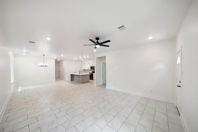 708 Azalea St, Prairie View, TX 77484 - unfurnished living room with a ceiling fan, baseboards, a sink, and recessed lighting