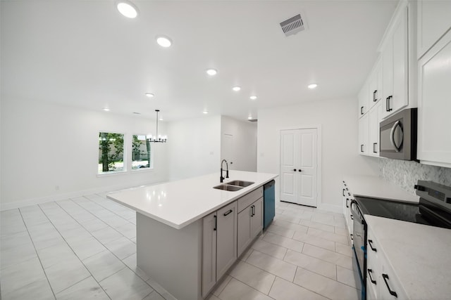 708 Azalea St, Prairie View, TX 77484 - kitchen with stainless steel appliances, a sink, an island with sink, light countertops, and recessed lighting