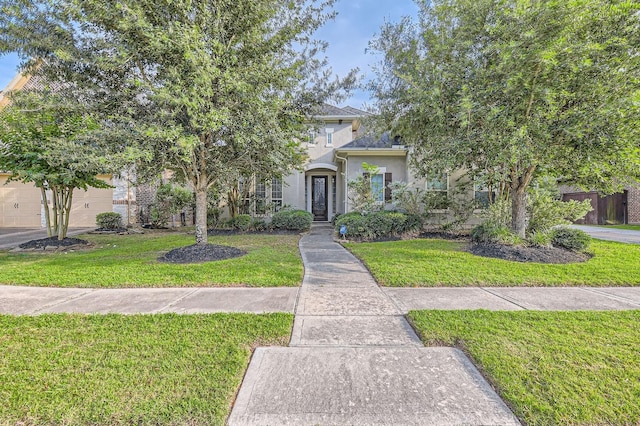 7203 Prairie Grass Ln, Katy, TX 77493 - obstructed view of property with stucco siding and a front yard
