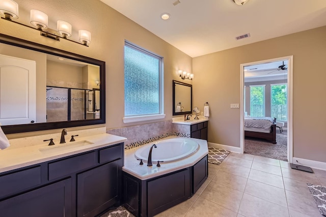 7203 Prairie Grass Ln, Katy, TX 77493 - ensuite bathroom with a shower stall, two vanities, a garden tub, baseboards, and tile patterned flooring