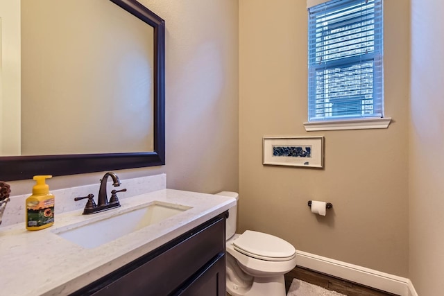 7203 Prairie Grass Ln, Katy, TX 77493 - bathroom with toilet, vanity, baseboards, and wood finished floors