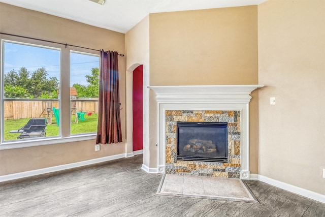7523 Chathan Glen Ln, Richmond, TX 77407 - unfurnished living room featuring wood finished floors, a fireplace, and baseboards