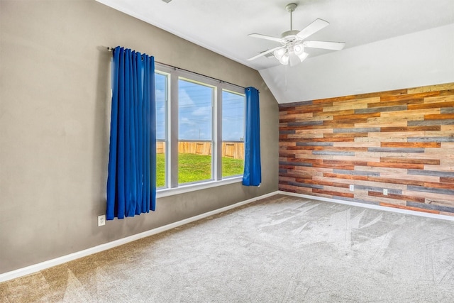 7523 Chathan Glen Ln, Richmond, TX 77407 - carpeted empty room with wooden walls, vaulted ceiling, a ceiling fan, and baseboards