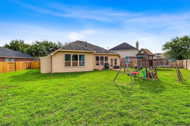 7523 Chathan Glen Ln, Richmond, TX 77407 - back of property featuring a trampoline, a playground, and cooling unit