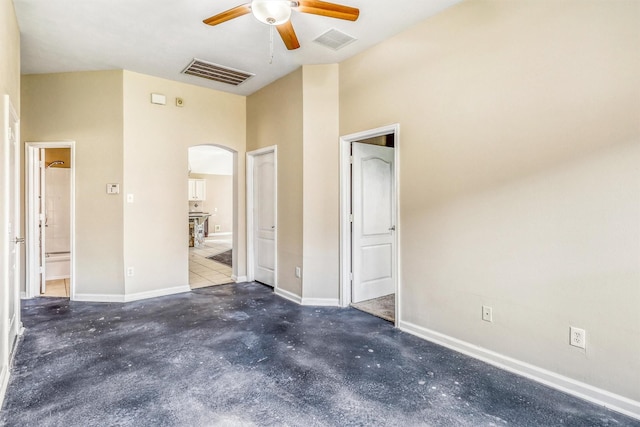 7523 Chathan Glen Ln, Richmond, TX 77407 - unfurnished bedroom with arched walkways, unfinished concrete flooring, ensuite bath, and baseboards