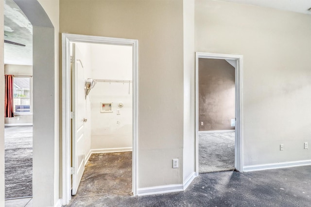 7523 Chathan Glen Ln, Richmond, TX 77407 - unfurnished bedroom featuring unfinished concrete floors, baseboards, arched walkways, and ensuite bathroom