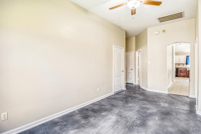 7523 Chathan Glen Ln, Richmond, TX 77407 - unfurnished bedroom featuring arched walkways, unfinished concrete floors, baseboards, and ceiling fan
