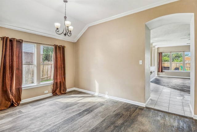 7523 Chathan Glen Ln, Richmond, TX 77407 - empty room with arched walkways, ornamental molding, lofted ceiling, wood finished floors, and a chandelier