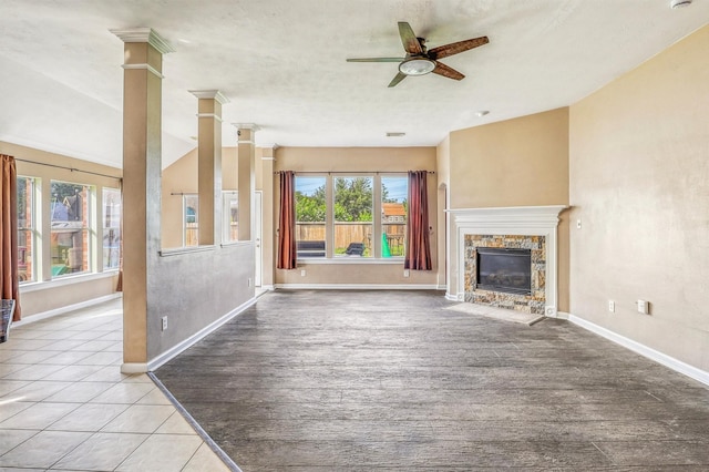 7523 Chathan Glen Ln, Richmond, TX 77407 - unfurnished living room with a ceiling fan, a fireplace, baseboards, and ornate columns