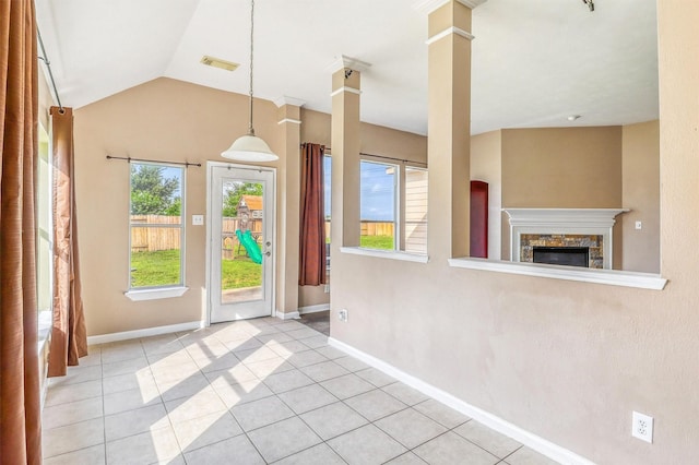 7523 Chathan Glen Ln, Richmond, TX 77407 - entrance foyer with light tile patterned floors, a stone fireplace, baseboards, vaulted ceiling, and ornate columns