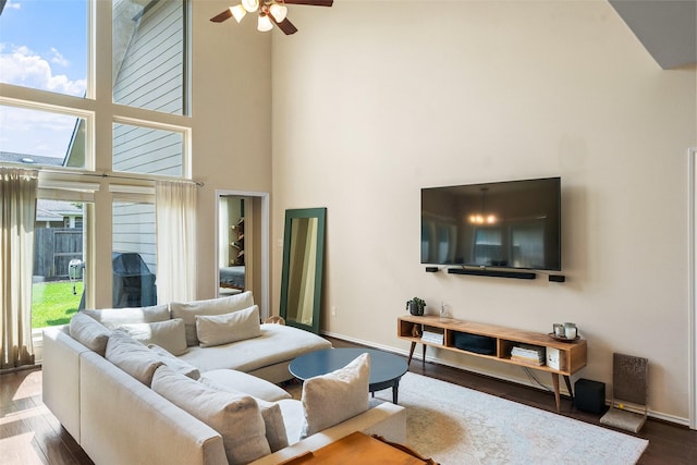 1406 Kallie Hills Ln, Spring, TX 77386 - living room with a high ceiling, wood finished floors, a ceiling fan, and baseboards