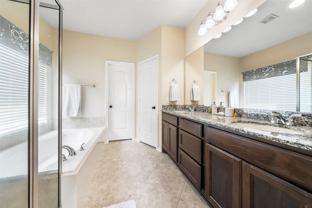 1406 Kallie Hills Ln, Spring, TX 77386 - bathroom with double vanity, a bath, plenty of natural light, and tile patterned flooring