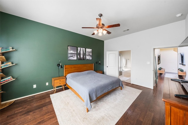 1406 Kallie Hills Ln, Spring, TX 77386 - bedroom with dark wood-style flooring, ensuite bath, a ceiling fan, and baseboards
