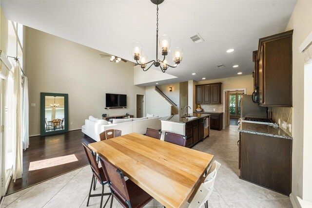 1406 Kallie Hills Ln, Spring, TX 77386 - dining space with a chandelier, light tile patterned flooring, and recessed lighting