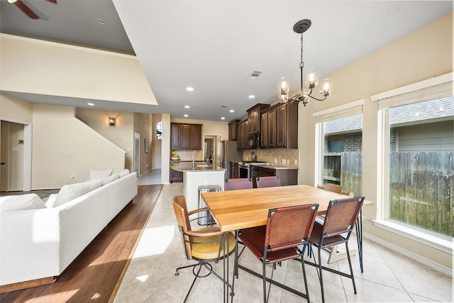 1406 Kallie Hills Ln, Spring, TX 77386 - dining space with a chandelier, plenty of natural light, light tile patterned floors, baseboards, and recessed lighting